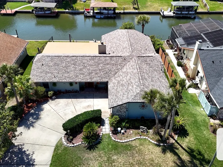 Aerial view of a home with a shingle roof
